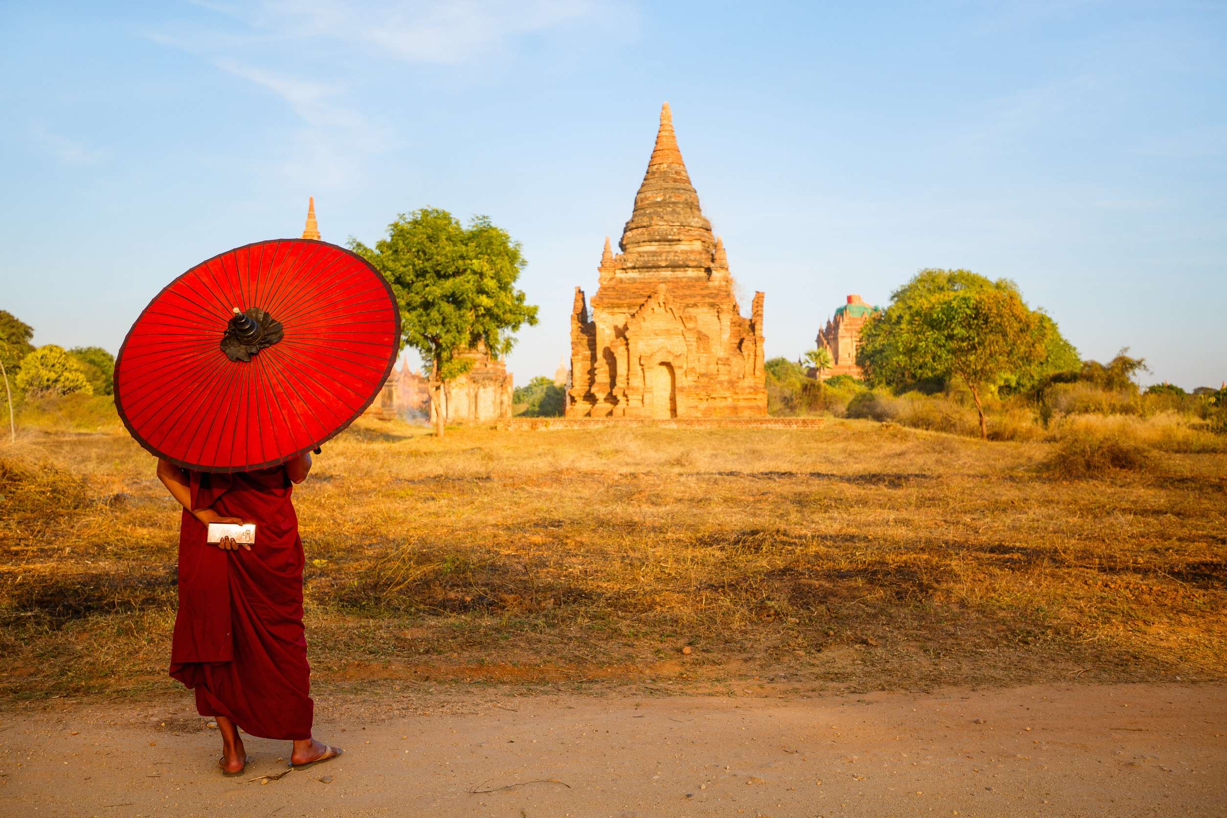 Back View Of Monk In Bagan Myanmar Enjoying View Of Ancient Pagodas