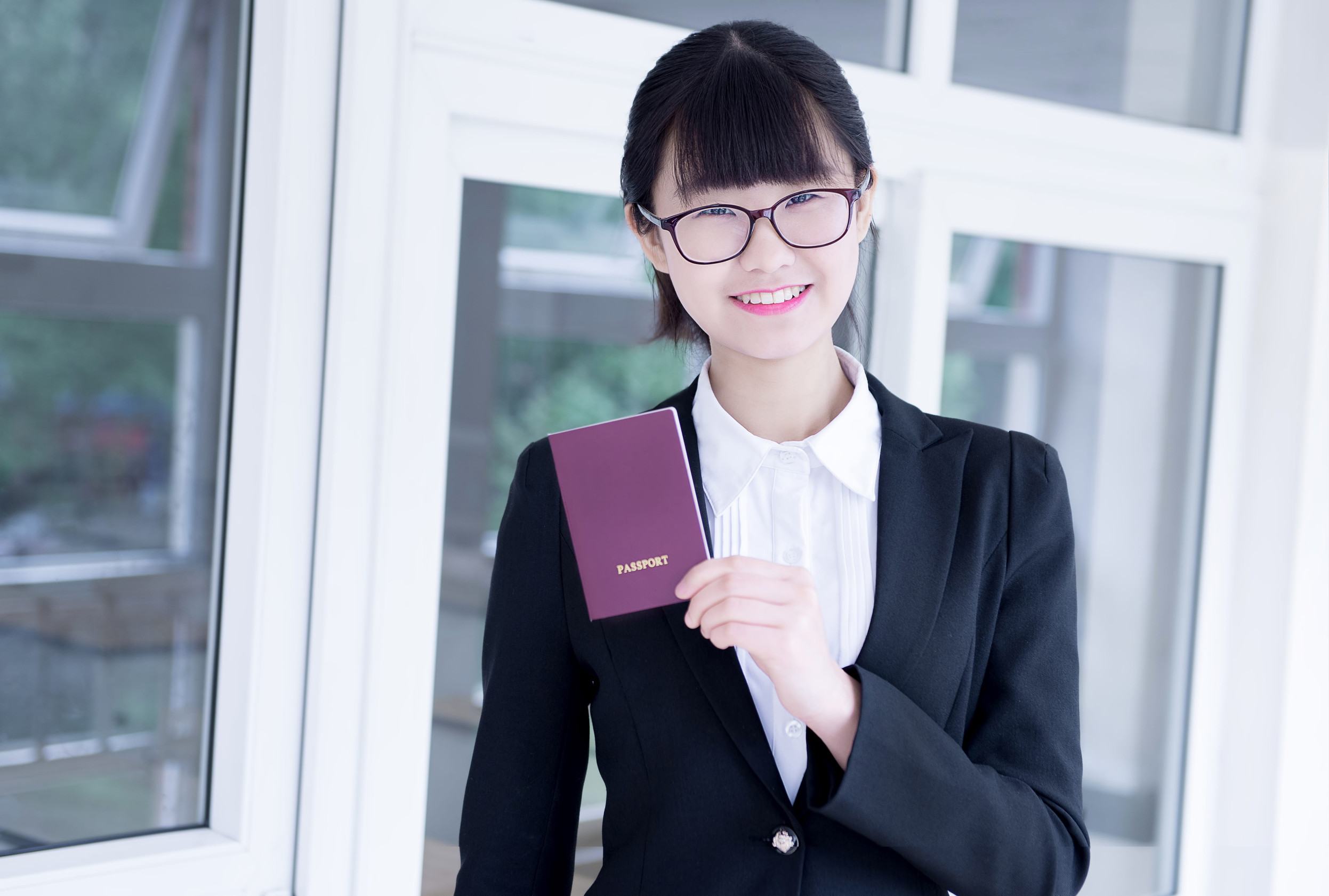 Business Woman In Office Holding Passport