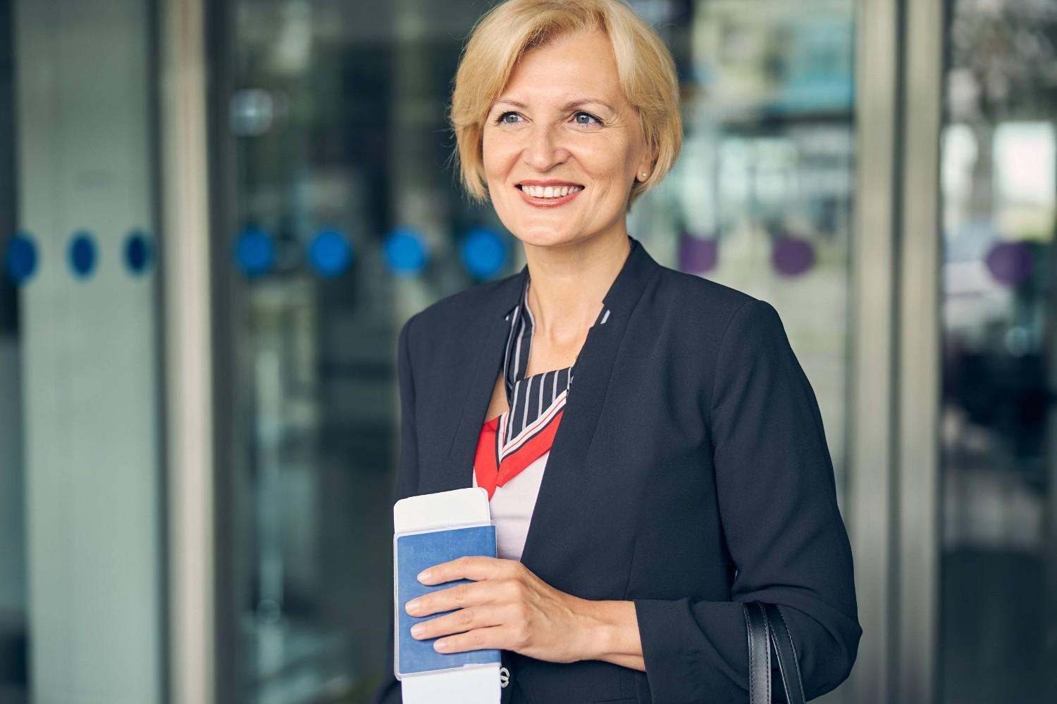 Businesswoman Holding Passport and Ticket