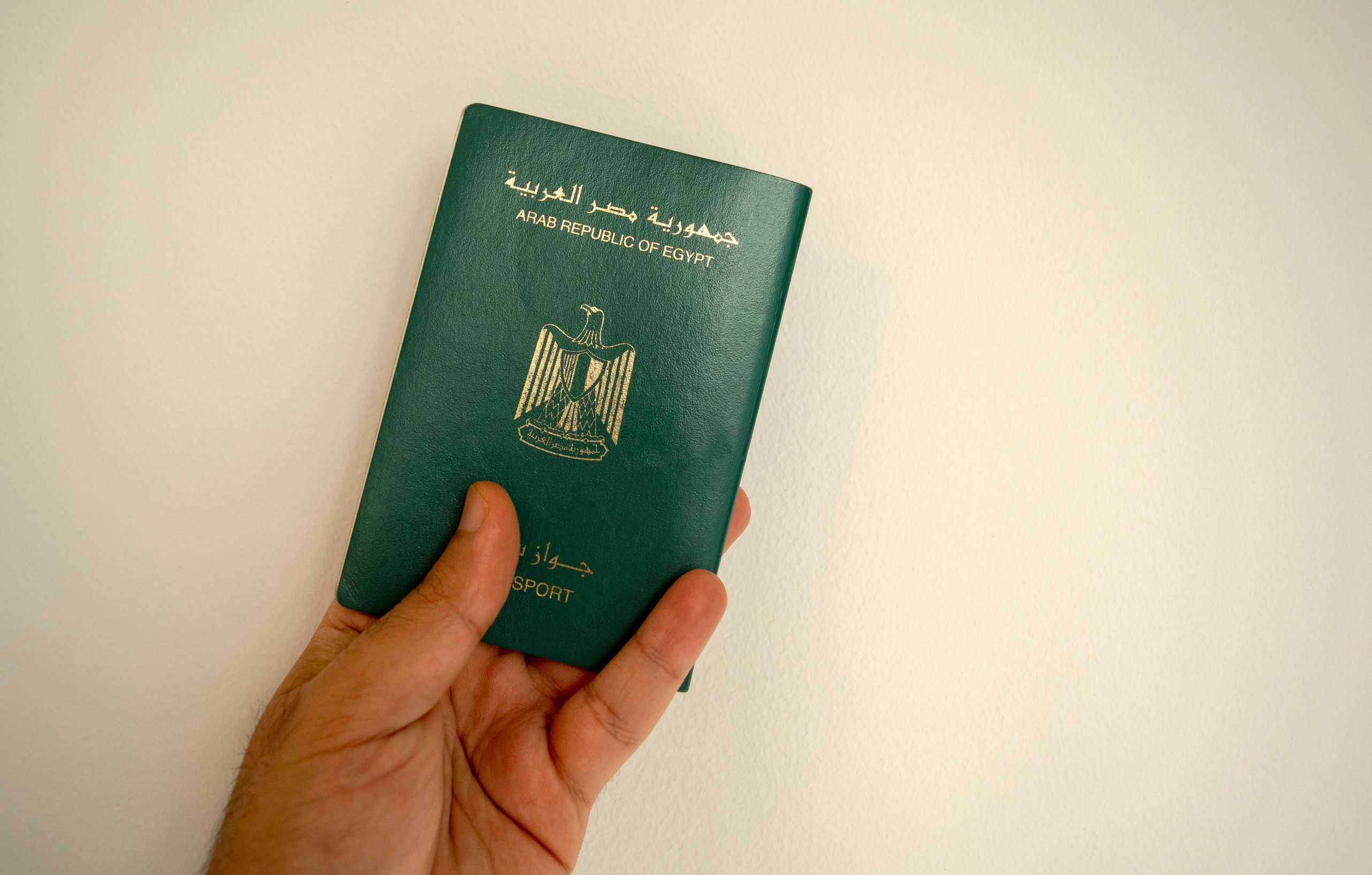 Egyptian passport in male hand man hand is holding Egypt international passport