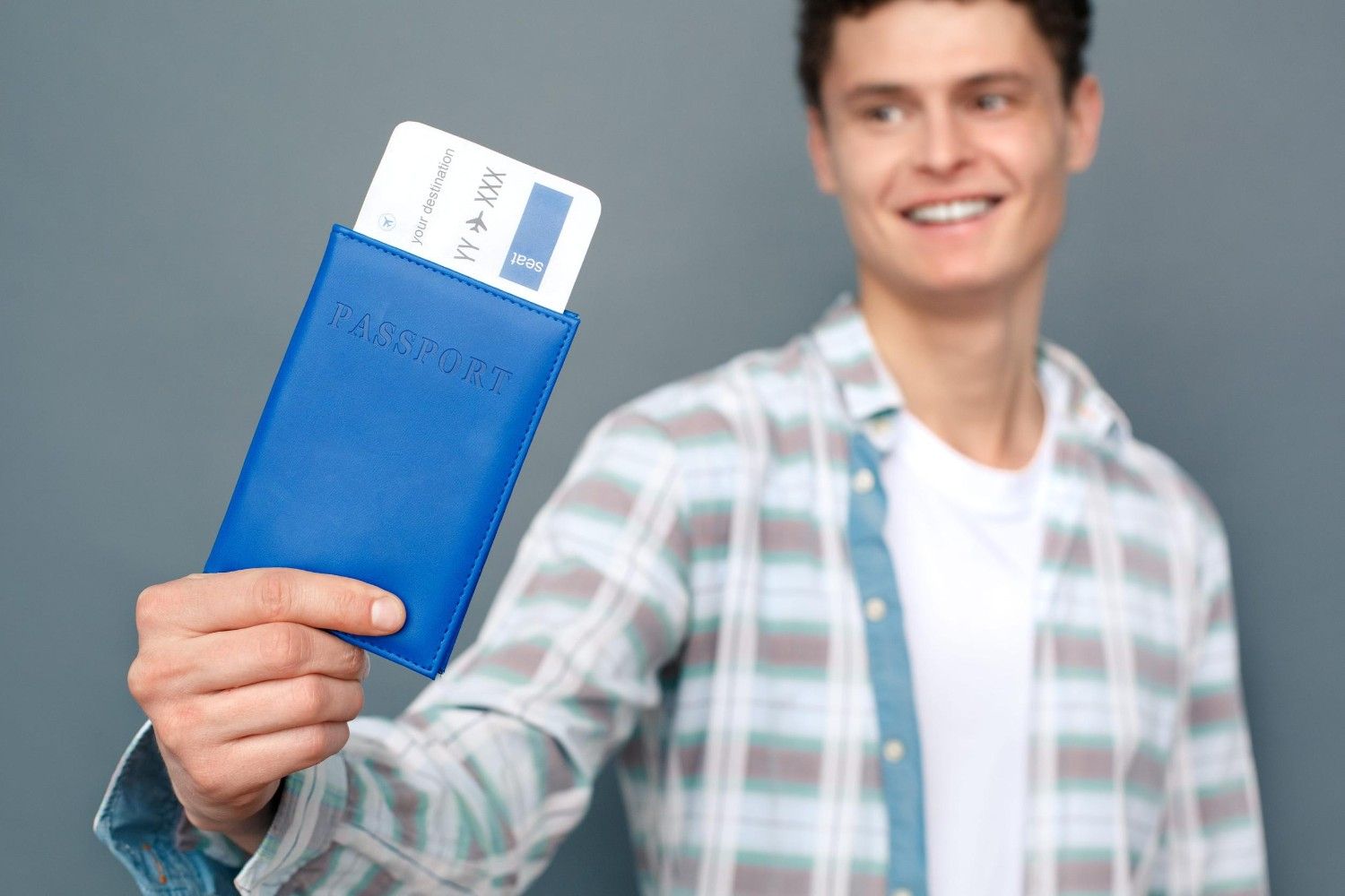 Man Isolated On Gray Wall Tourism Concept Standing With Passport