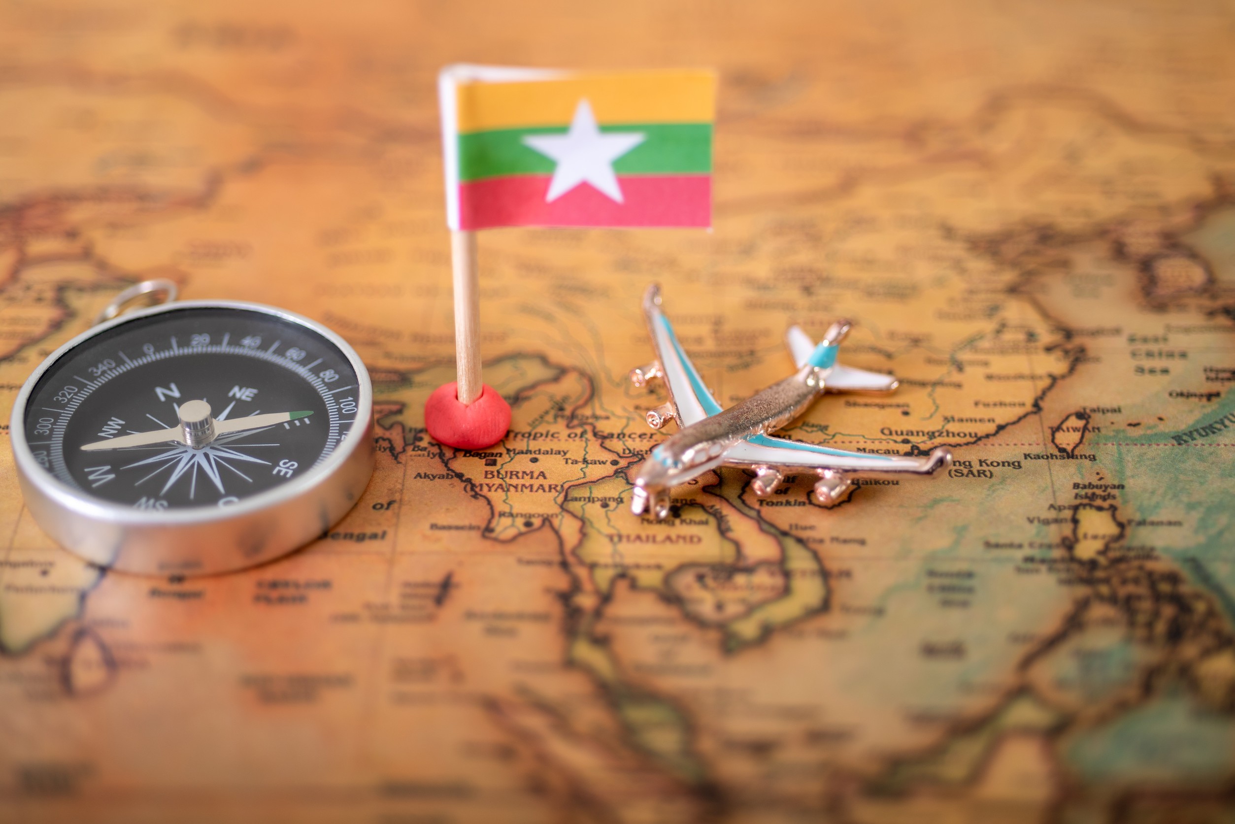 Myanmar Flag Airplane And Compass On The World Map The Concept Of Travel And Tourism